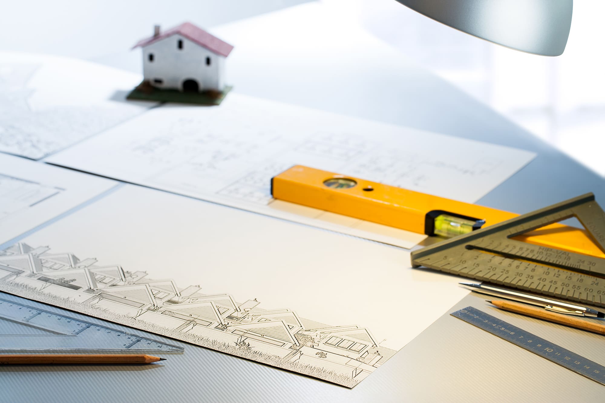 Detail of architect desk with technical drawings and measuring tools.